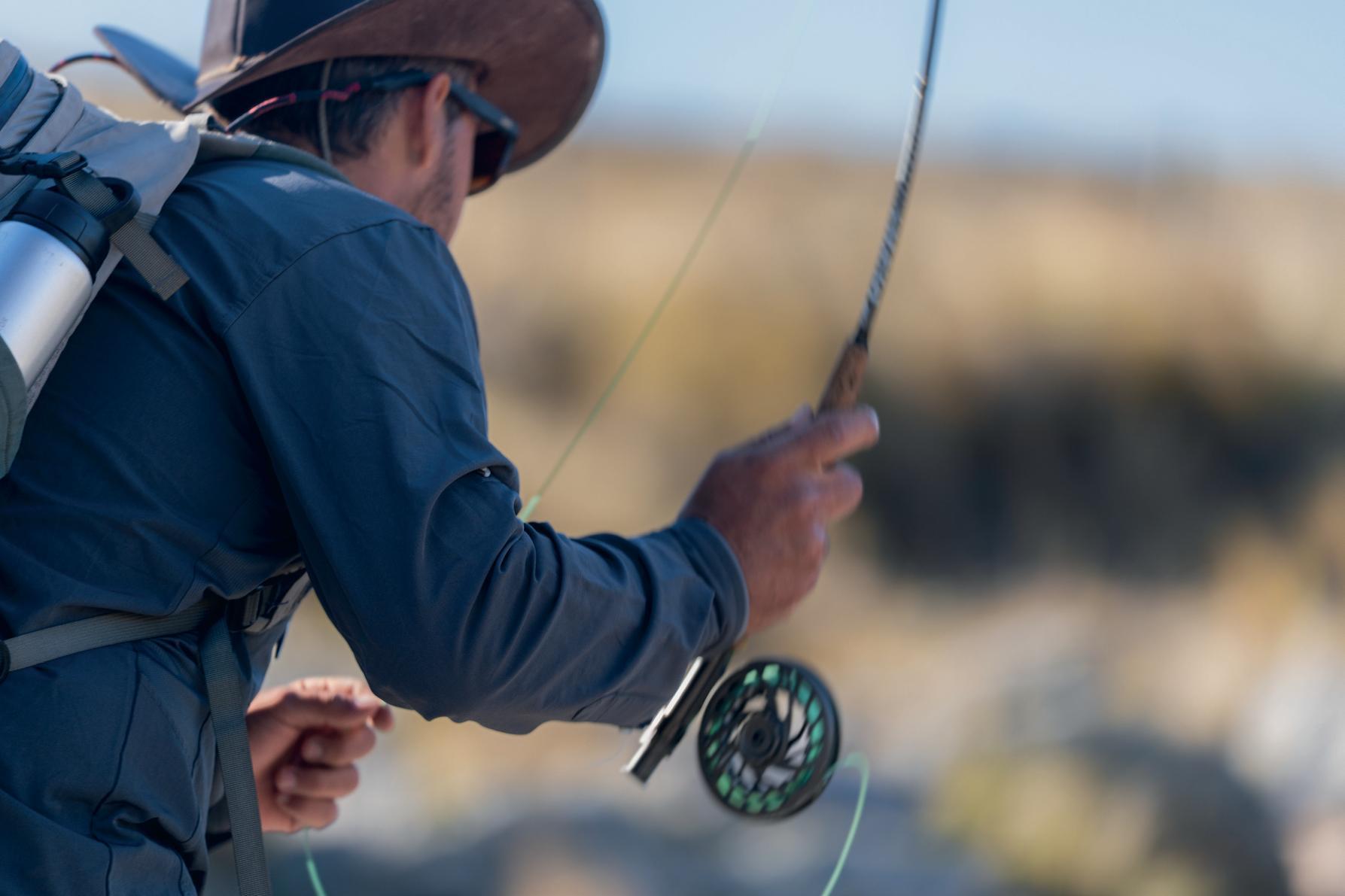 Angler casting a fly rod, close up
